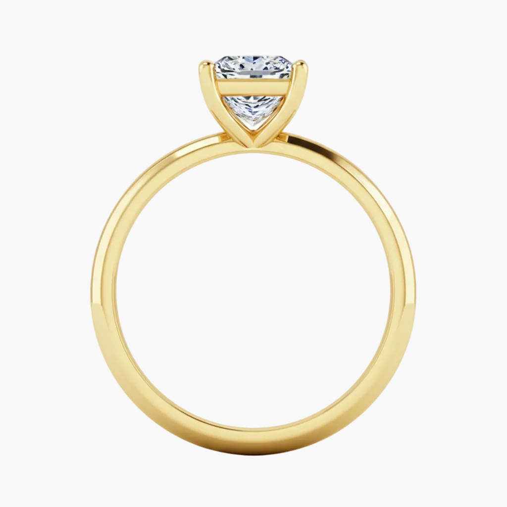 Gold ring with a diamond on a white background