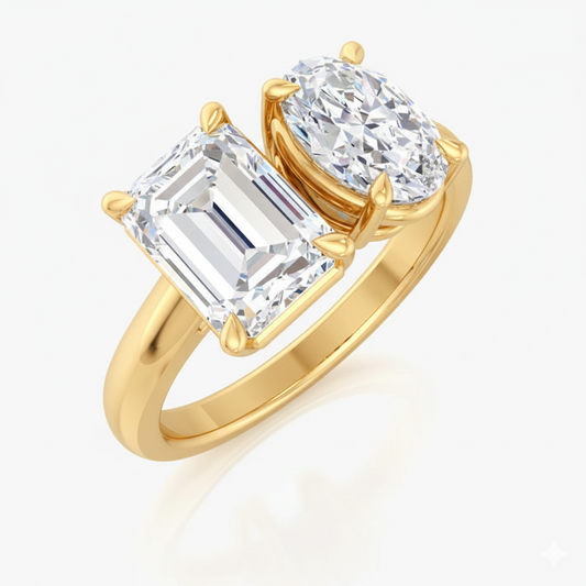 Gold ring with two large diamonds on a white background