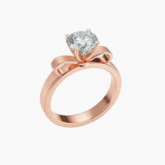 Rose gold ring with a heart-shaped diamond on a white background