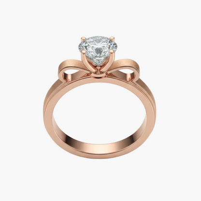 Rose gold ring with a diamond on a light gray background