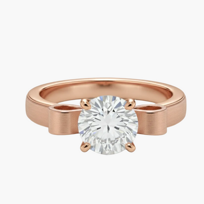 Rose gold ring with a diamond on a light gray background