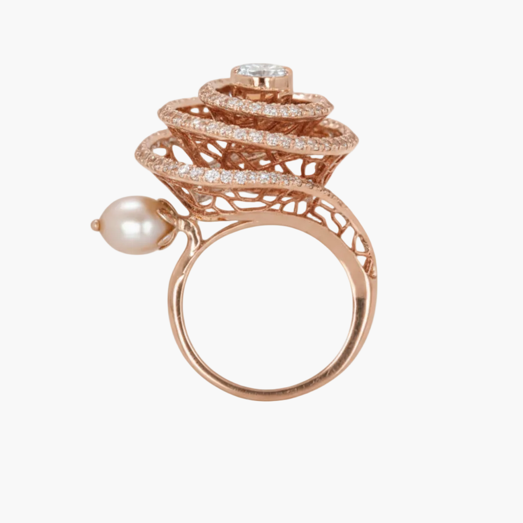 Rose gold ring with pearl and diamond accents on a white background