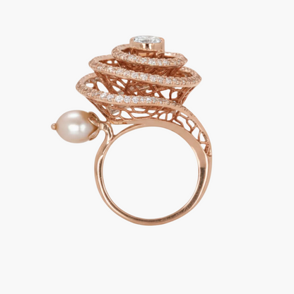 Rose gold ring with pearl and diamond accents on a white background
