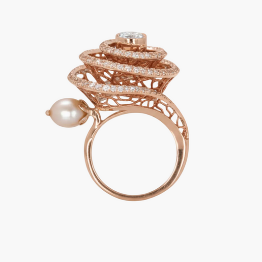 Rose gold ring with pearl and diamond accents on a white background