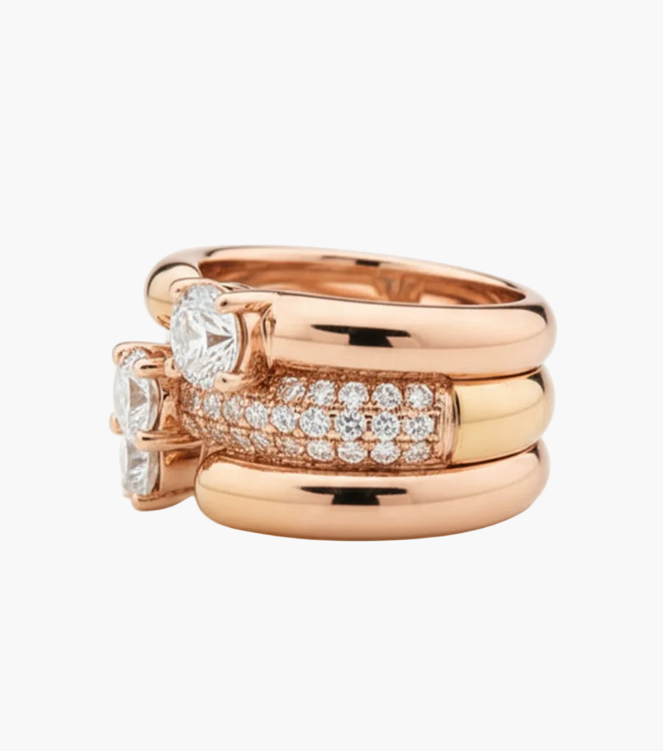 Set of rose gold rings with diamond accents on a white background