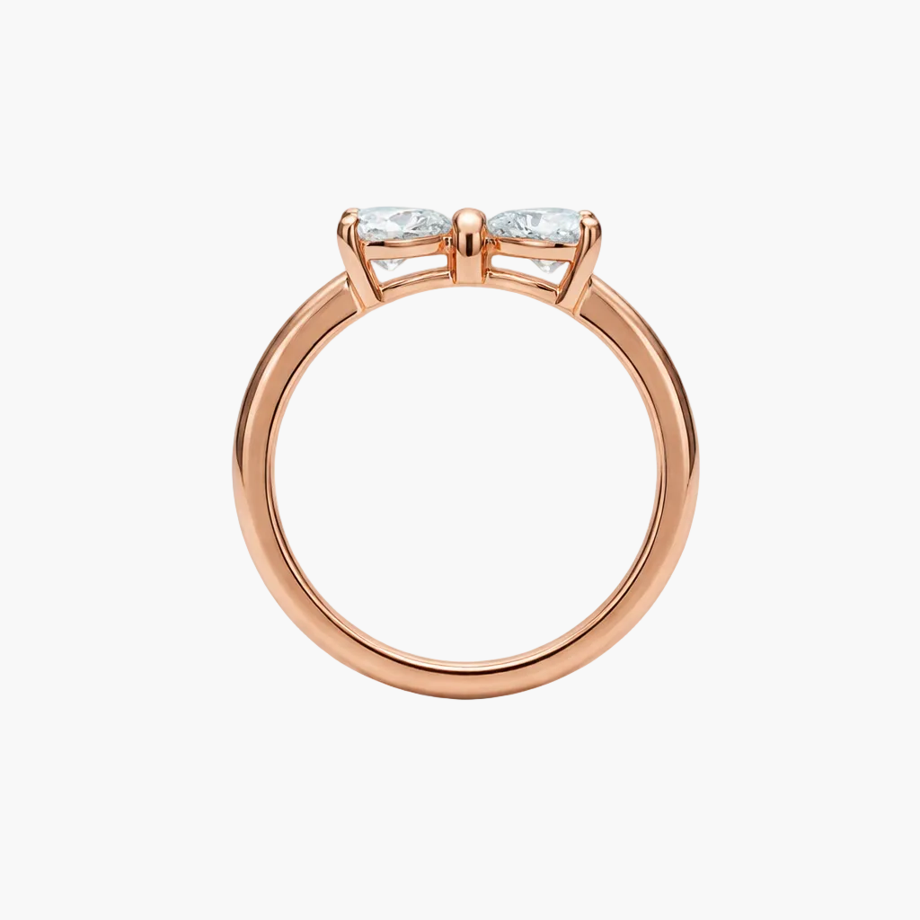Rose gold ring with three diamonds on a white background