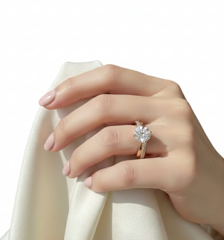 Hand wearing a diamond ring on a white background