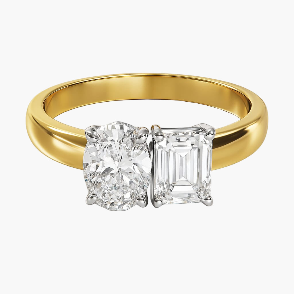 Gold ring with two diamonds on a white background