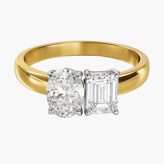 Gold ring with two diamonds on a white background