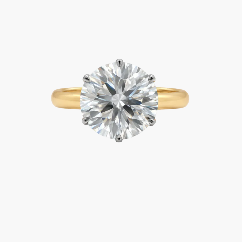 Gold ring with a large diamond on a white background