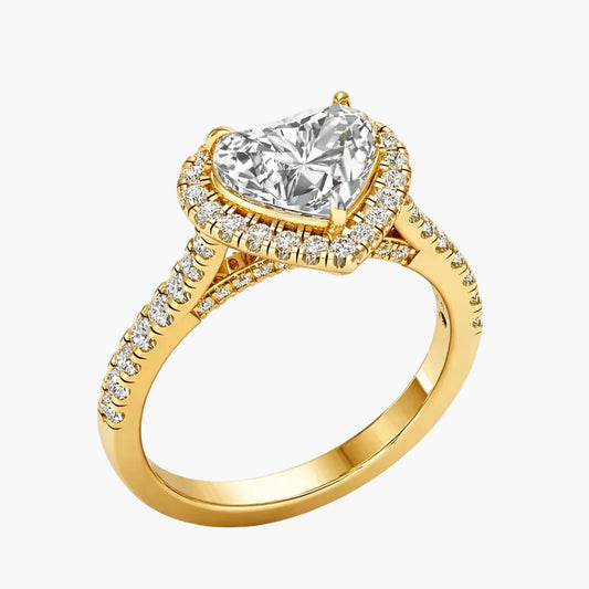 Gold ring with a heart-shaped diamond on a white background