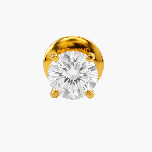 Gold earring with a clear gemstone on a white background