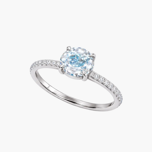 Silver ring with a blue gemstone on a white background