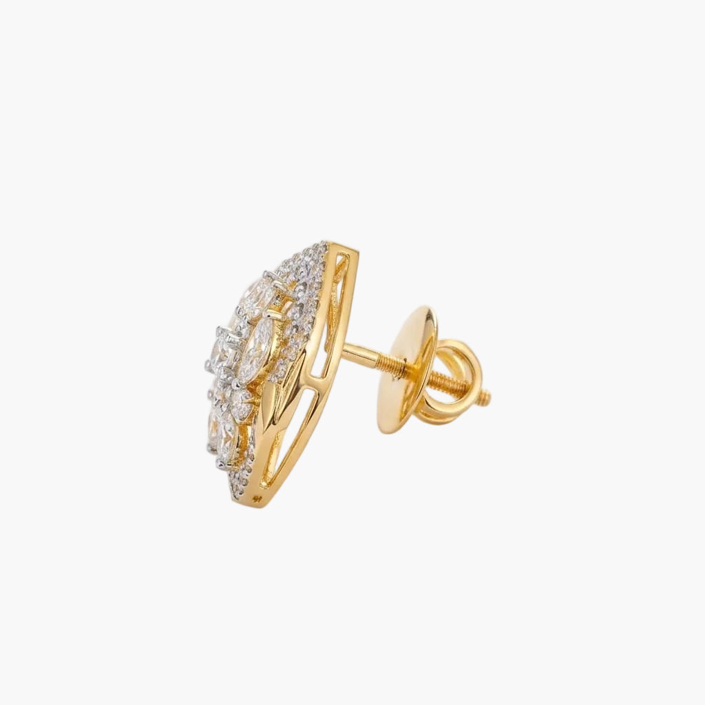 Gold earring with clear gemstones on a light gray background
