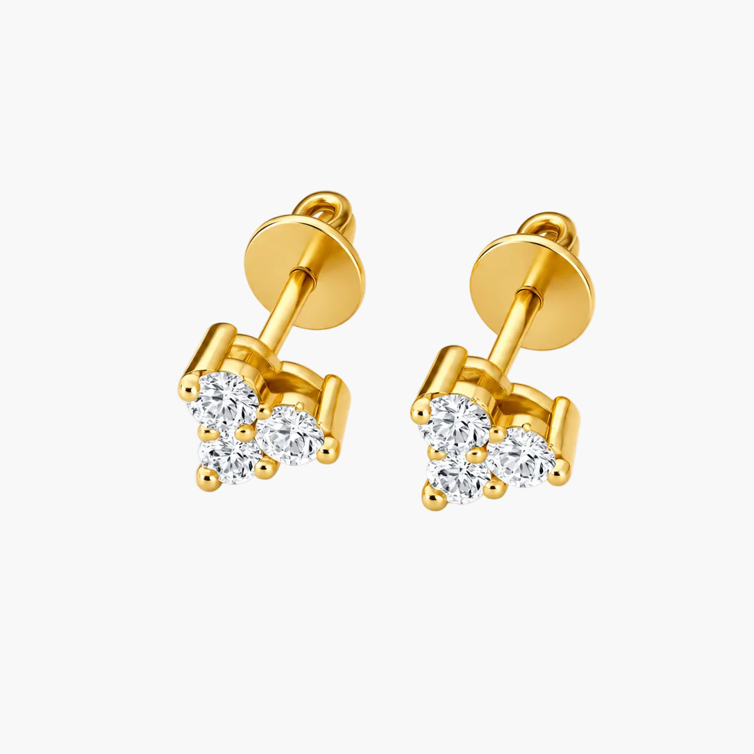 A pair of gold stud earrings with a small cluster of clear round-cut gemstones, shown on a clean white background.