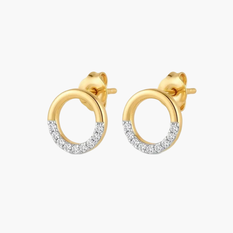 A pair of gold huggie hoop stud earrings with a pavé-set row of clear stones along the lower half of each hoop, shown on a plain white background.