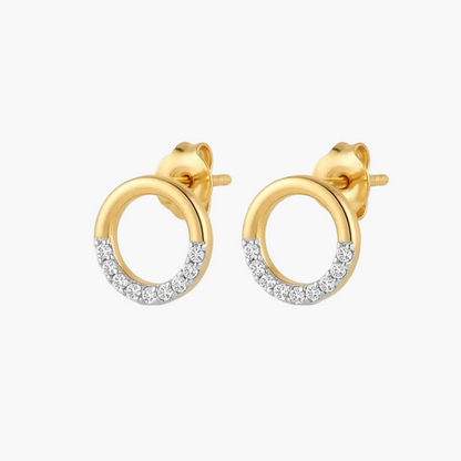 A pair of gold huggie hoop stud earrings with a pavé-set row of clear stones along the lower half of each hoop, shown on a plain white background.