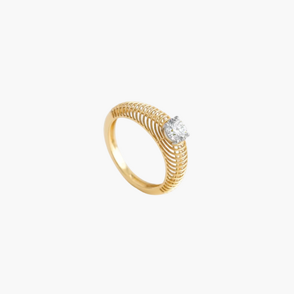 Gold ring with a diamond on a light gray background