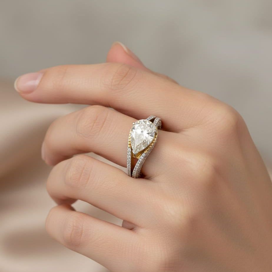 Hand wearing a diamond ring with a soft background