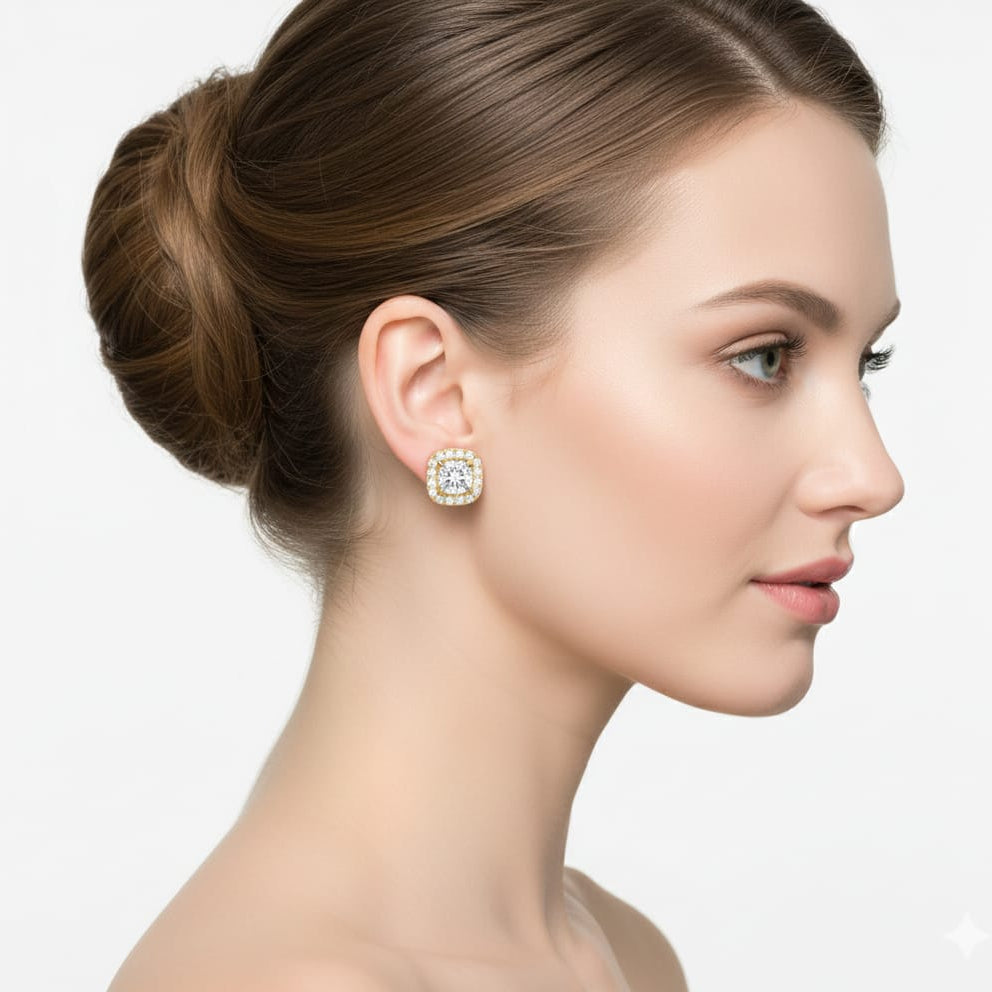 Woman wearing diamond earrings with a plain background