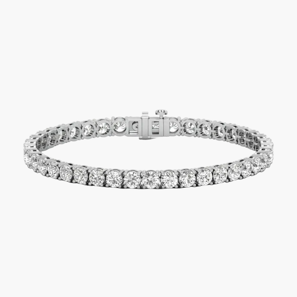 A silver tennis bracelet featuring round-cut clear stones, shown on a plain white background.