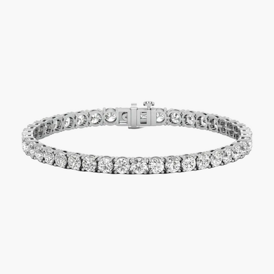 A silver tennis bracelet featuring round-cut clear stones, shown on a plain white background.