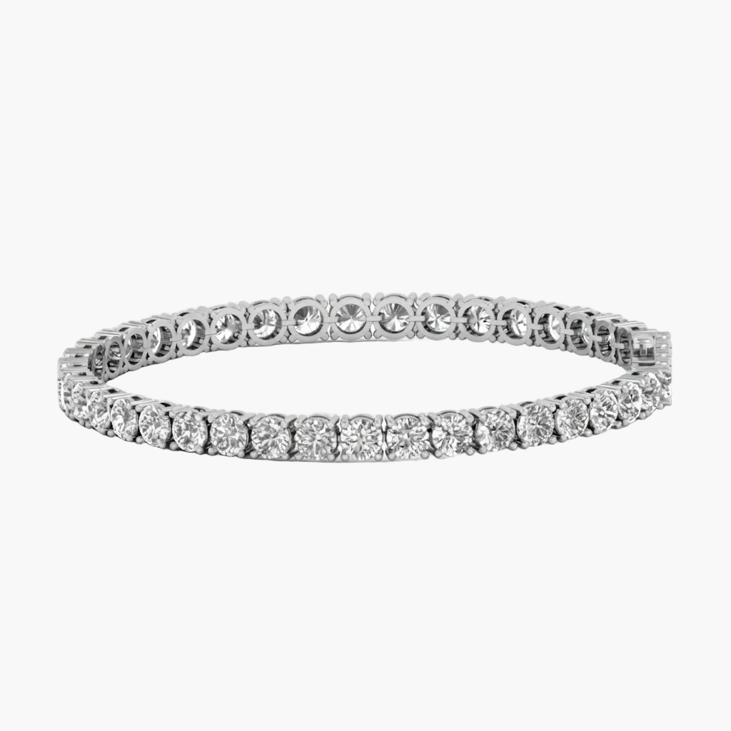 A silver tennis bracelet with a continuous line of round-cut clear gemstones, shown against a plain white background.