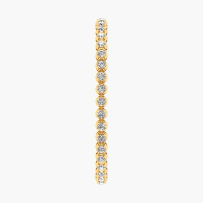 Gold bracelet with clear gemstones on a white background