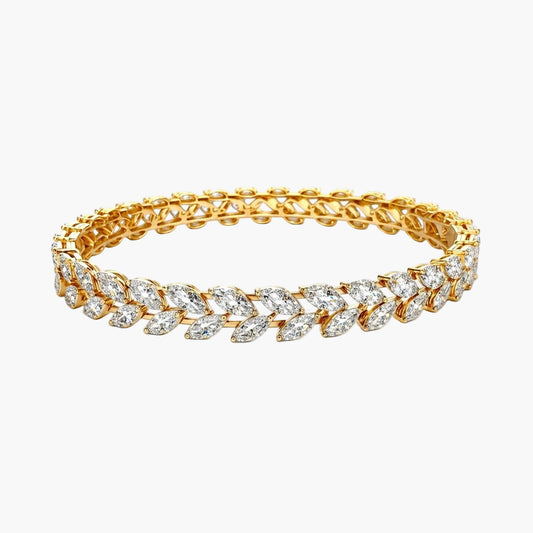 Gold bracelet with clear gemstones on a white background