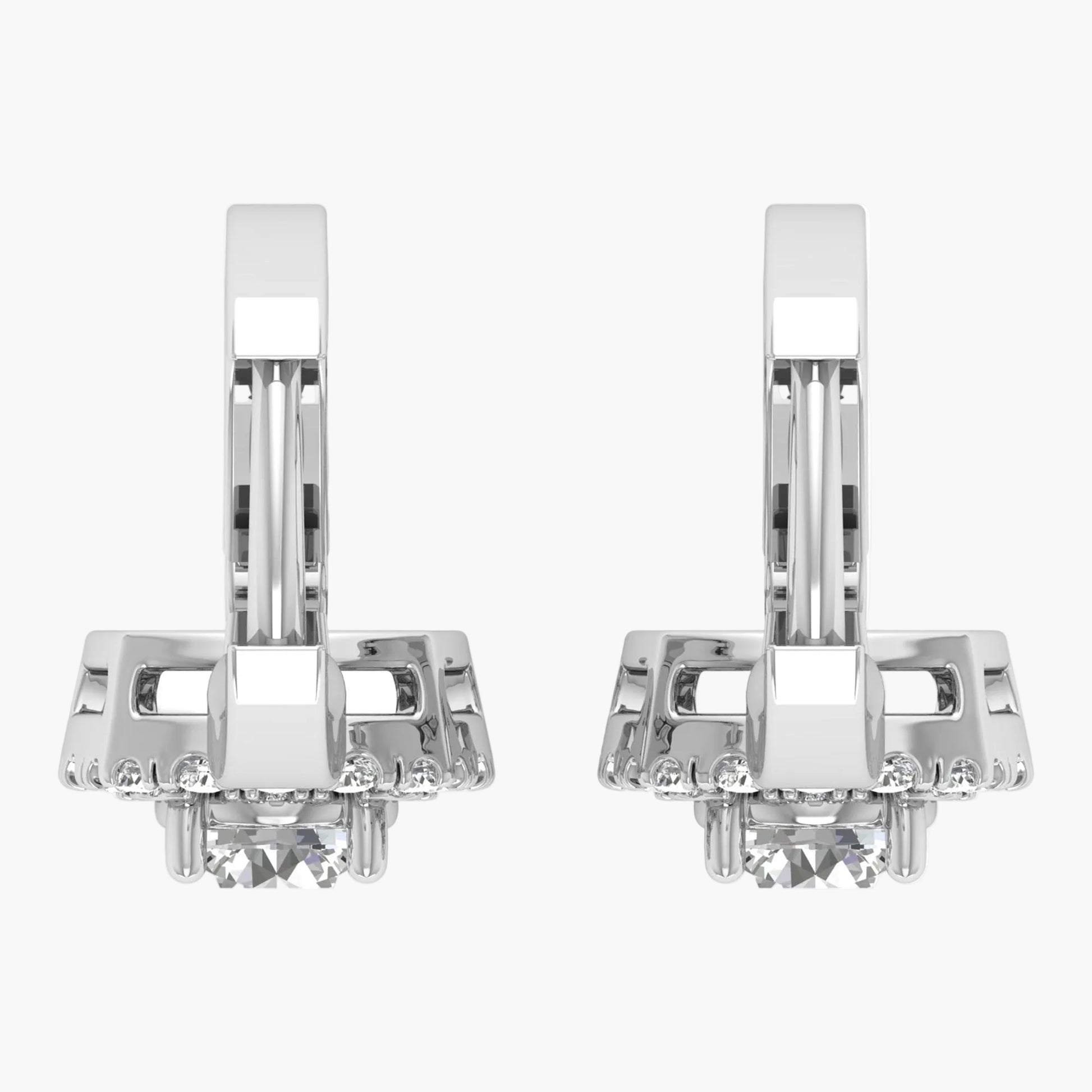 Pair of silver earrings with clear gemstones on a white background