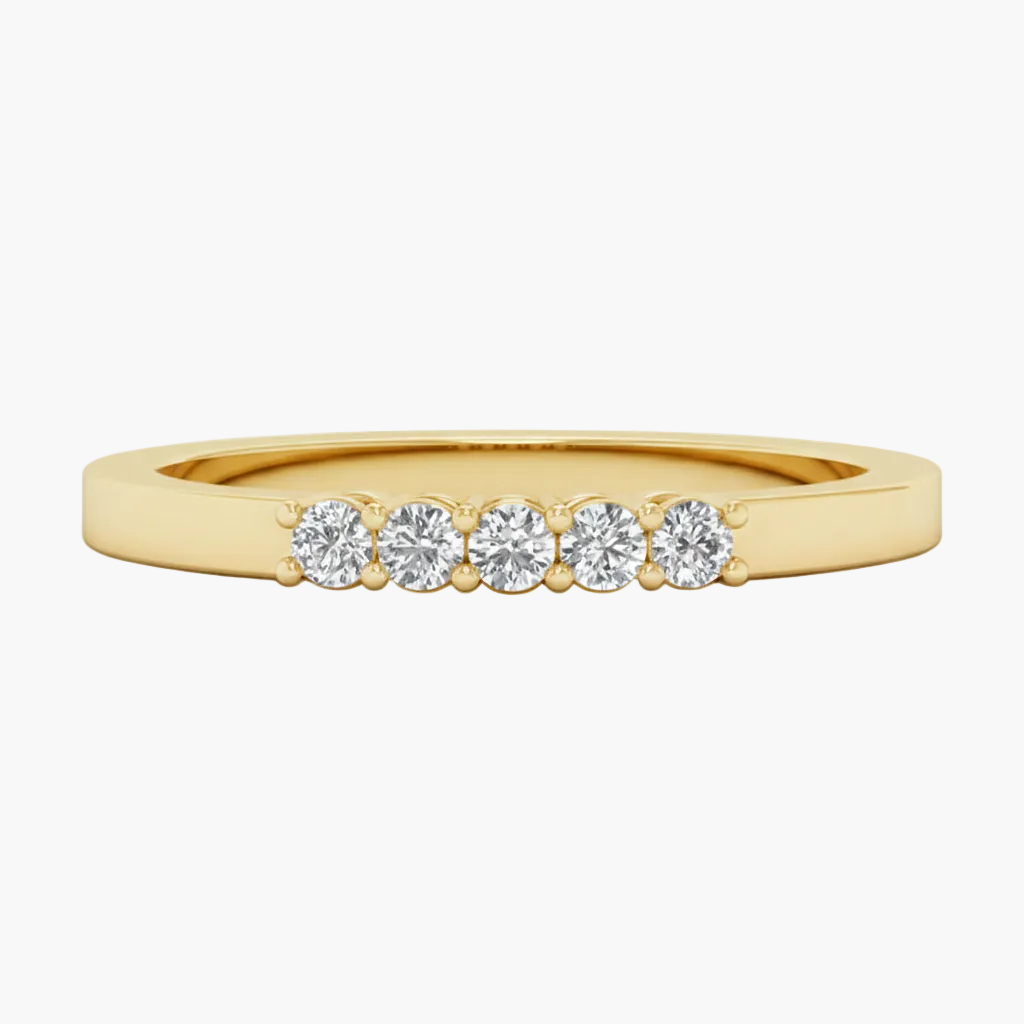Gold ring with five diamonds on a white background