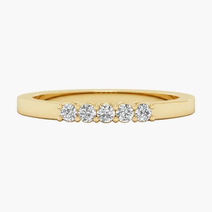 Gold ring with five diamonds on a white background