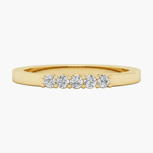 Gold ring with five diamonds on a white background