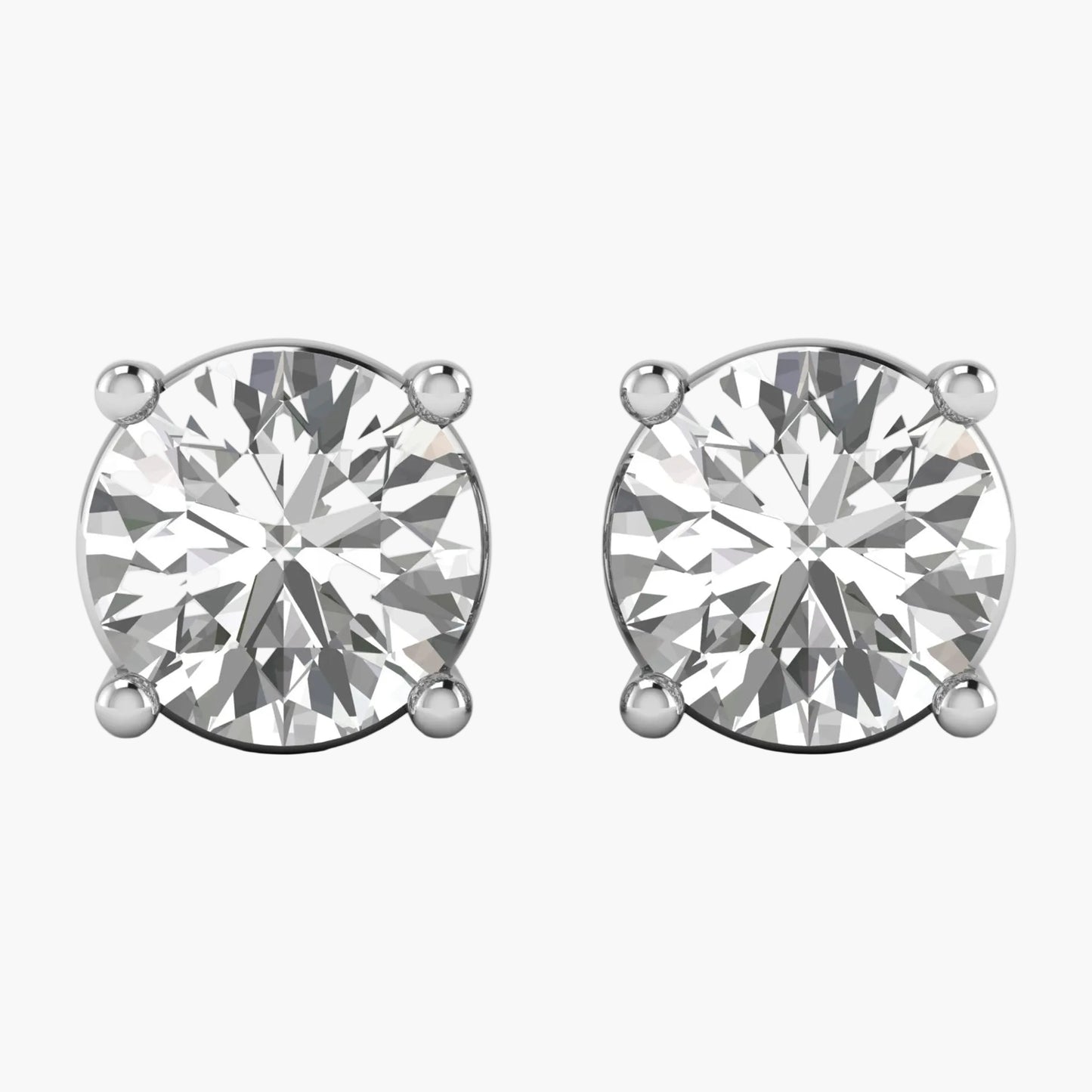Pair of diamond stud earrings on a white background