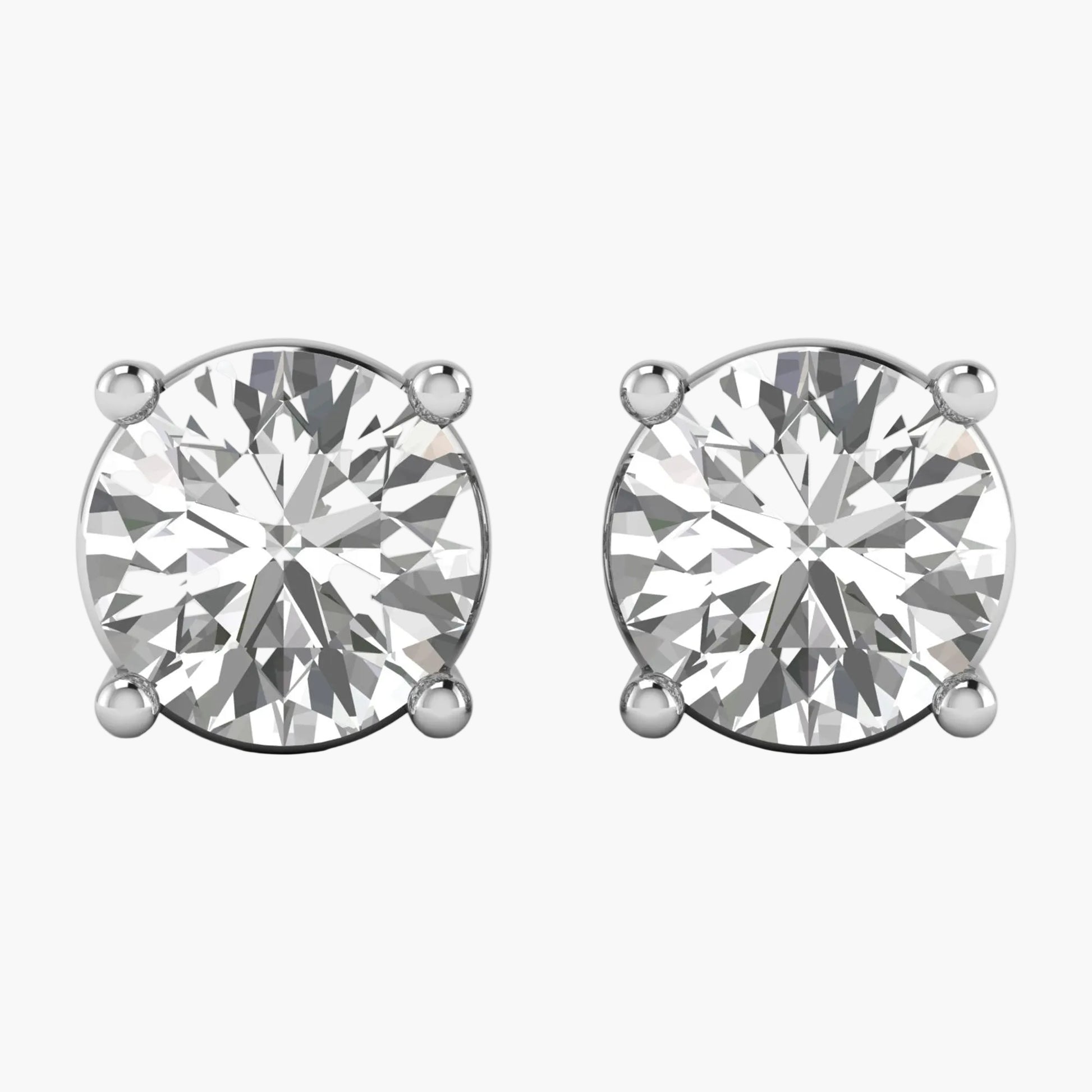 Pair of diamond stud earrings on a white background