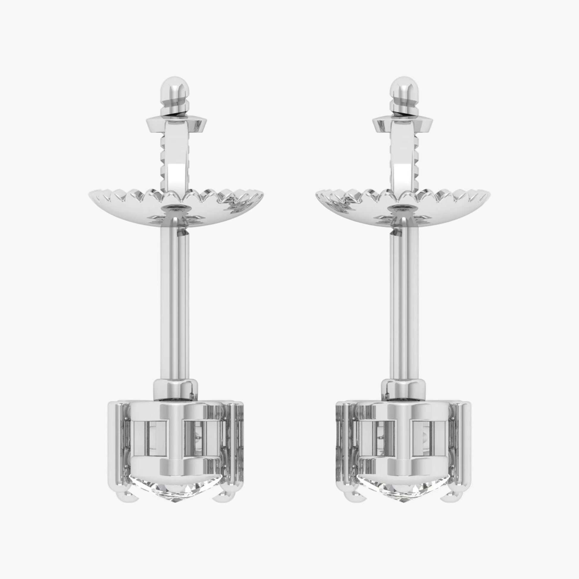 Pair of silver earrings with intricate designs on a white background