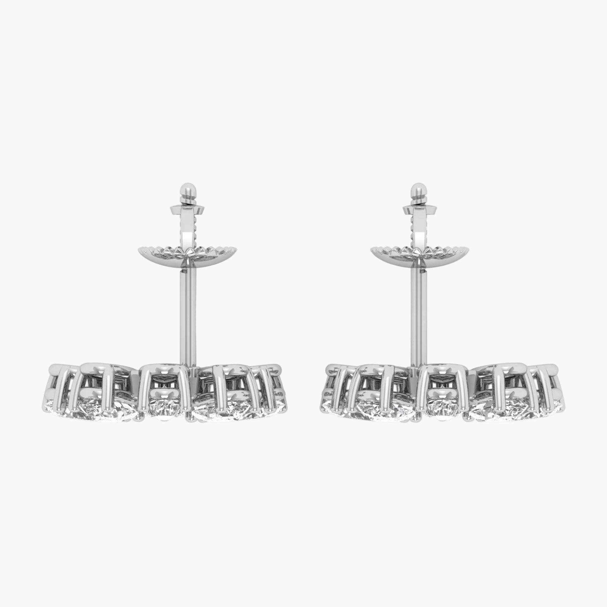 Pair of silver earrings with clear gemstones on a white background