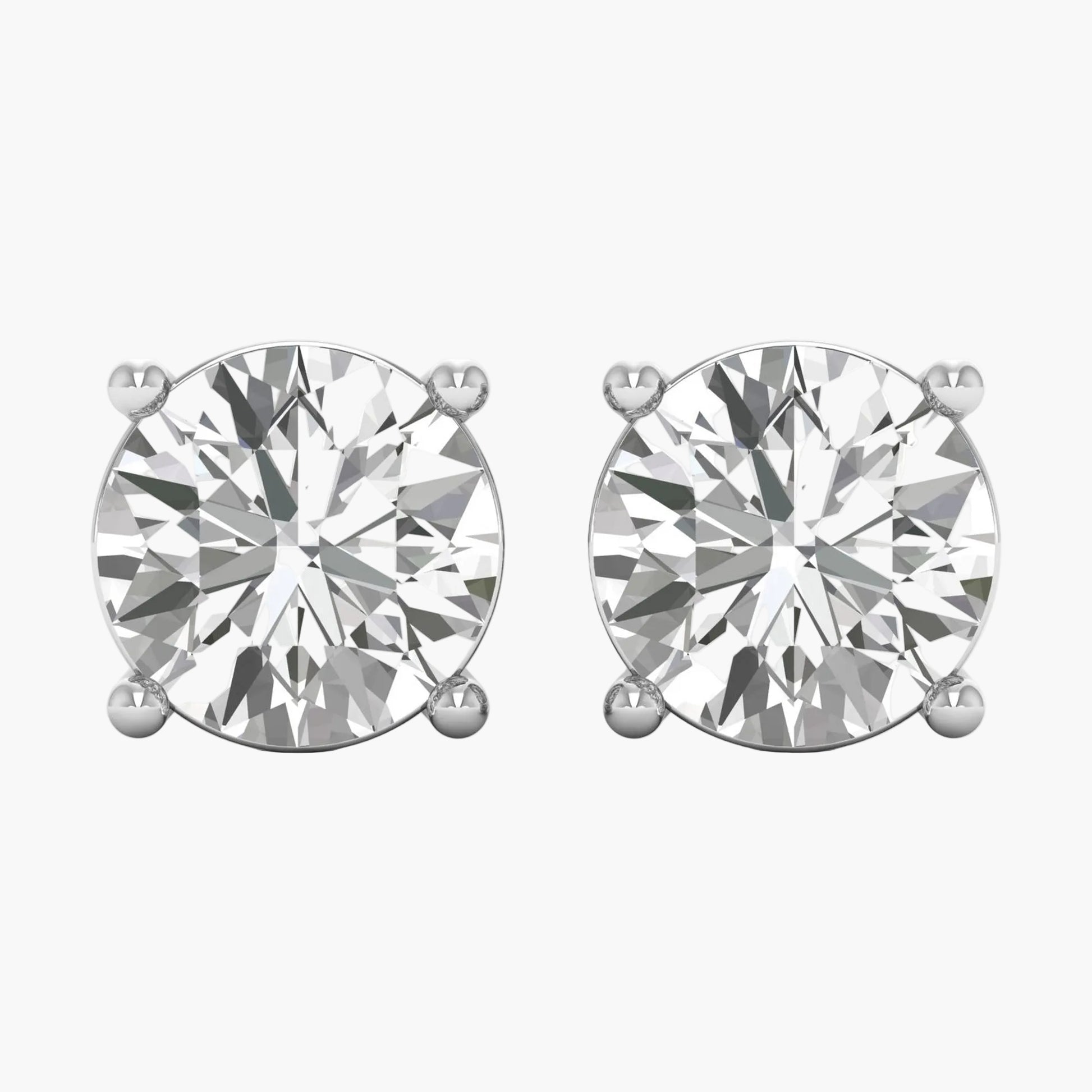 Pair of diamond stud earrings on a white background