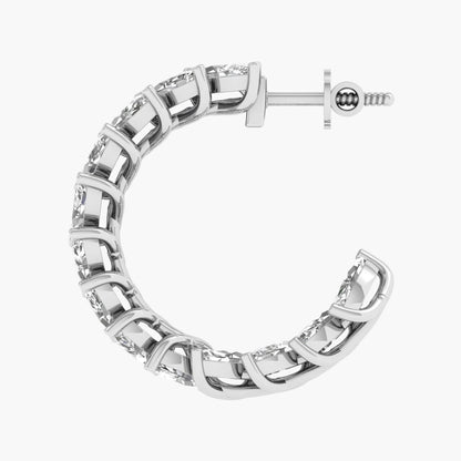 Silver hoop earring with clear gemstones on a white background