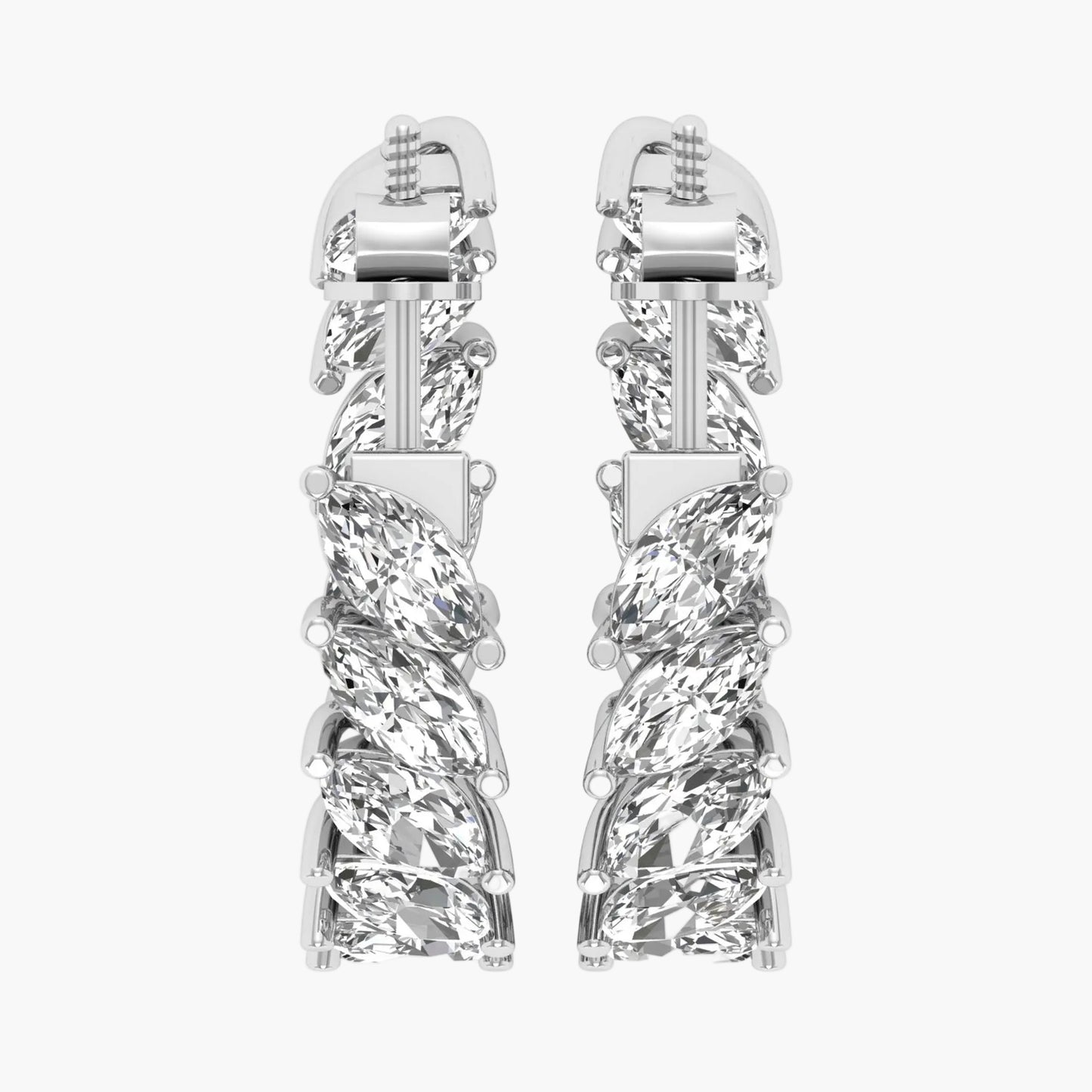 Pair of silver earrings with intricate design on a white background