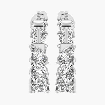 Pair of silver earrings with intricate design on a white background
