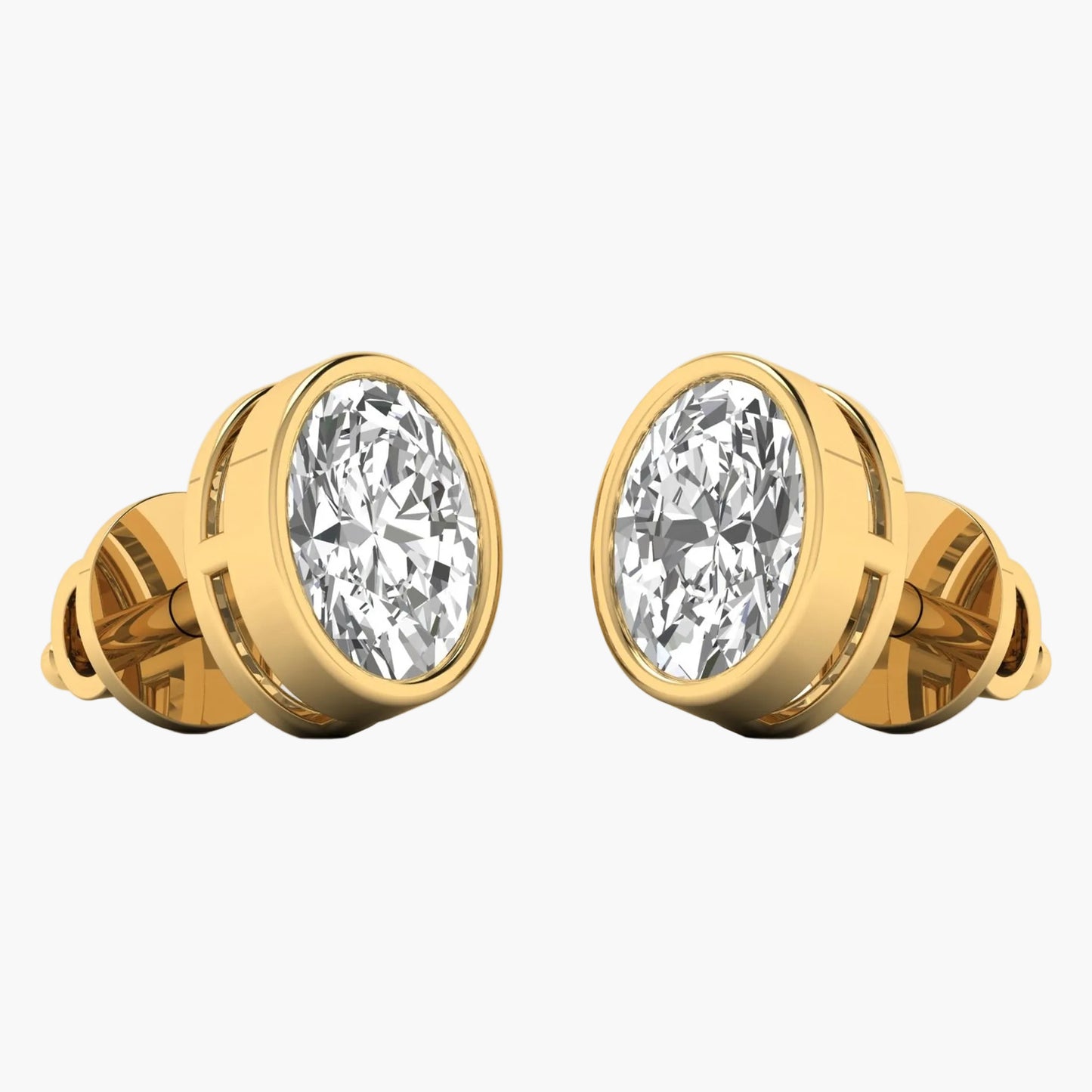 Gold earrings with large clear gemstones on a white background