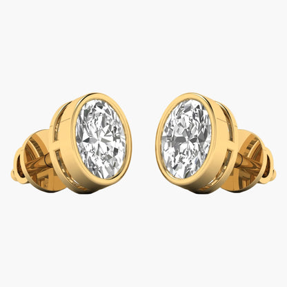 Gold earrings with large clear gemstones on a white background