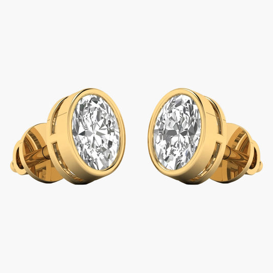 Gold earrings with large clear gemstones on a white background