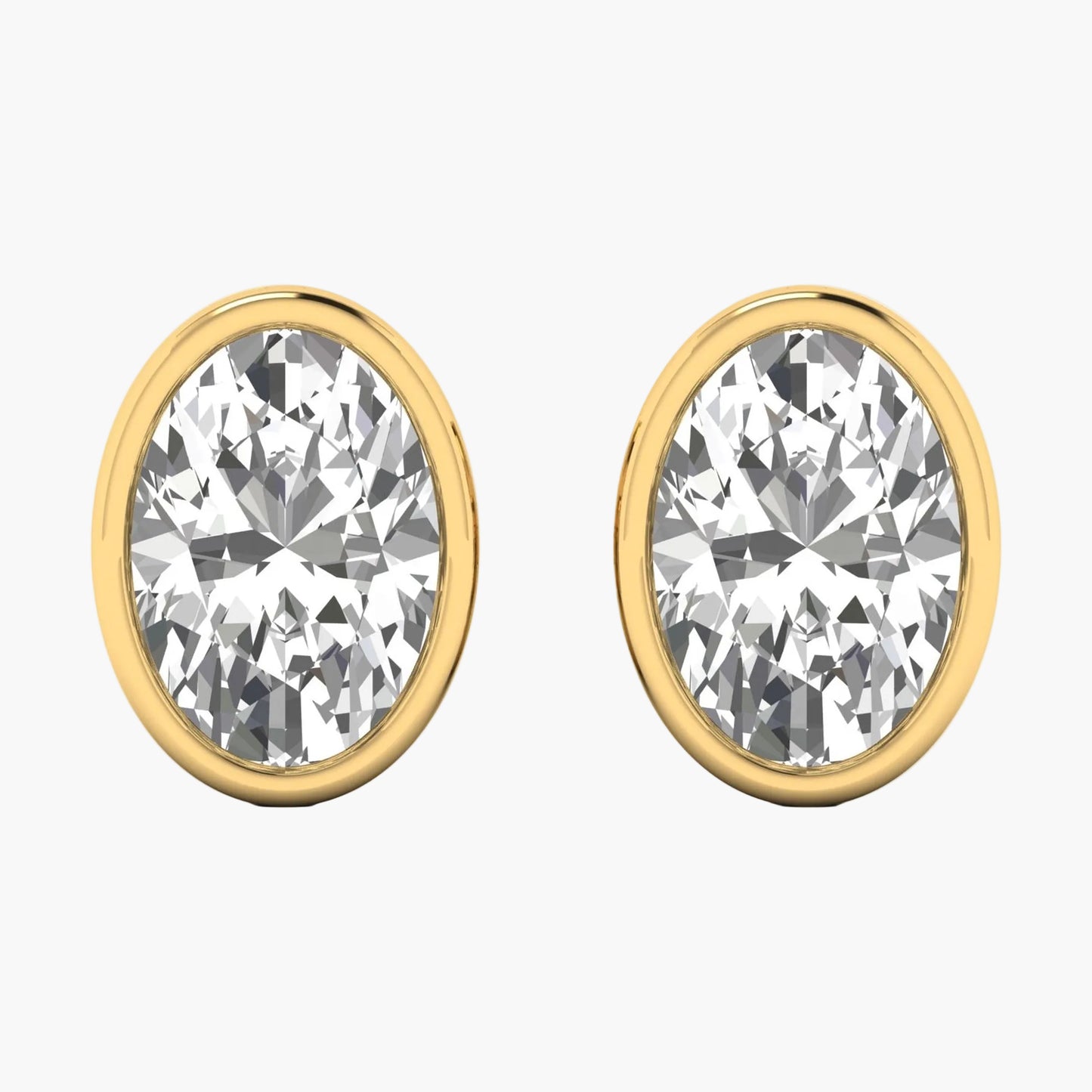 Gold earrings with clear gemstones on a white background