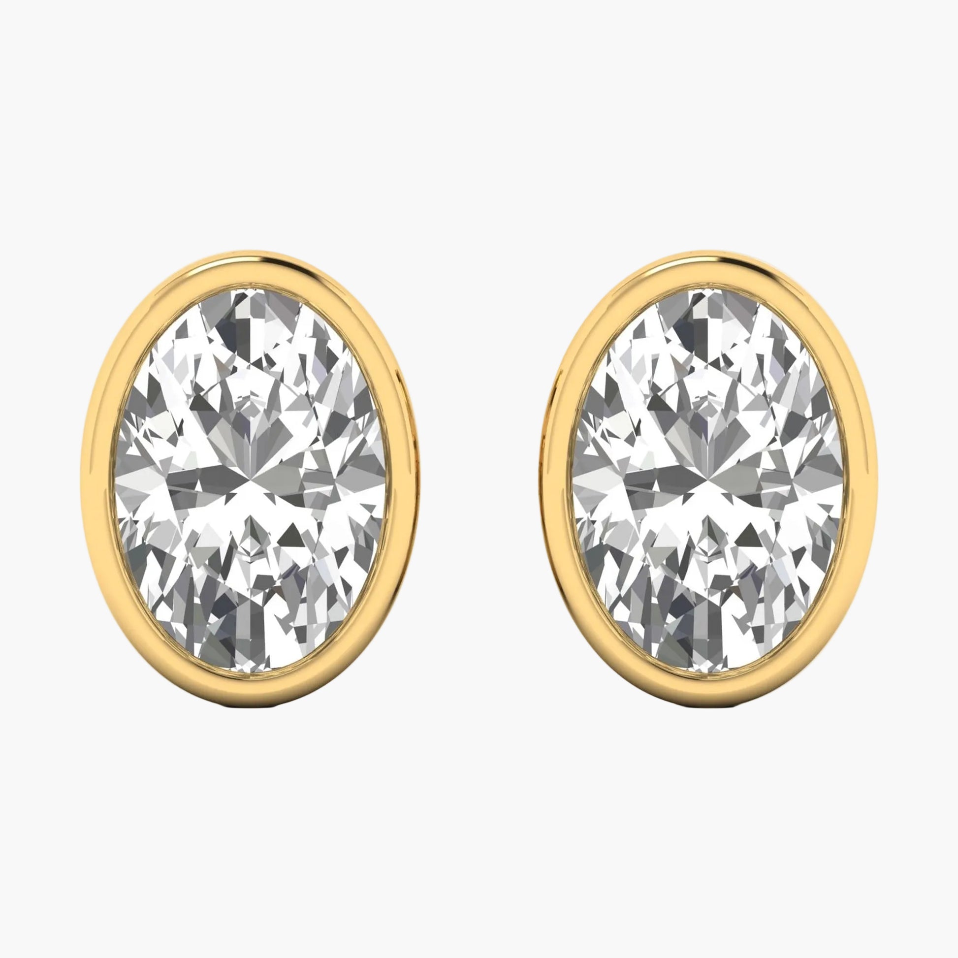 Gold earrings with clear gemstones on a white background