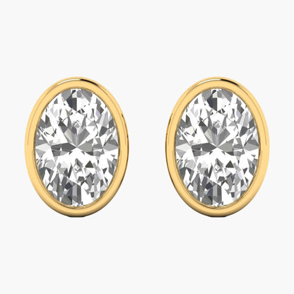 Gold earrings with clear gemstones on a white background