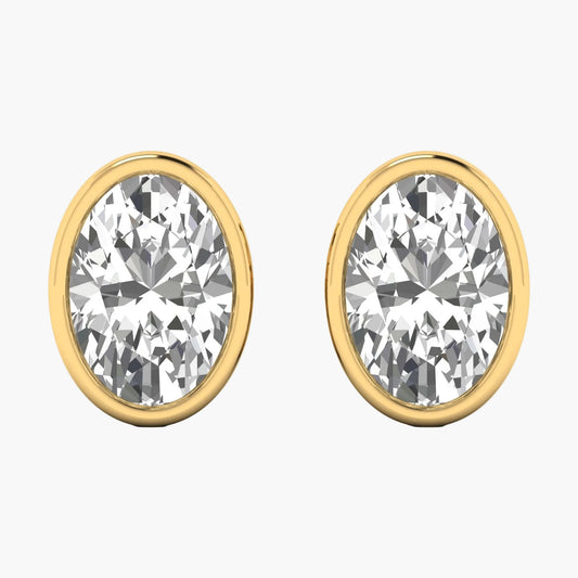 Gold earrings with clear gemstones on a white background