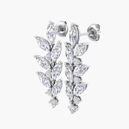 Pair of silver earrings with clear gemstones on a white background