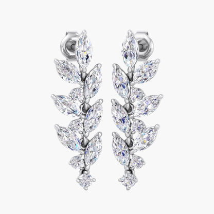Pair of silver earrings with clear gemstones on a white background